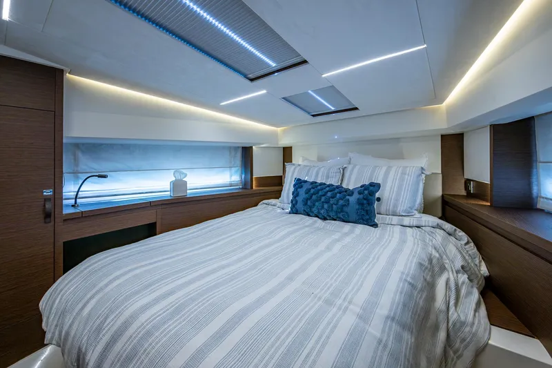 Pamper You Yacht Photos Pics Luxurious bedroom interior of 2019 Prestige 460 yacht with modern lighting and cozy bedding.