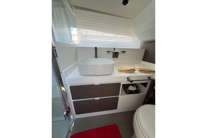  Yacht Photos Pics Modern bathroom interior of 2021 Fiart Seawalker 43 yacht with sleek sink and storage.
