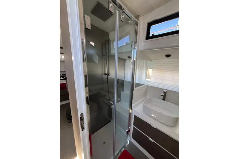  Yacht Photos Pics Modern bathroom interior of 2021 Fiart Seawalker 43 yacht with glass shower and sleek sink.