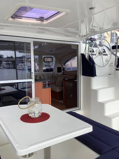 Merry Mac Yacht Photos Pics Interior of 2013 Leopard 44 catamaran with seating, table, and helm station.