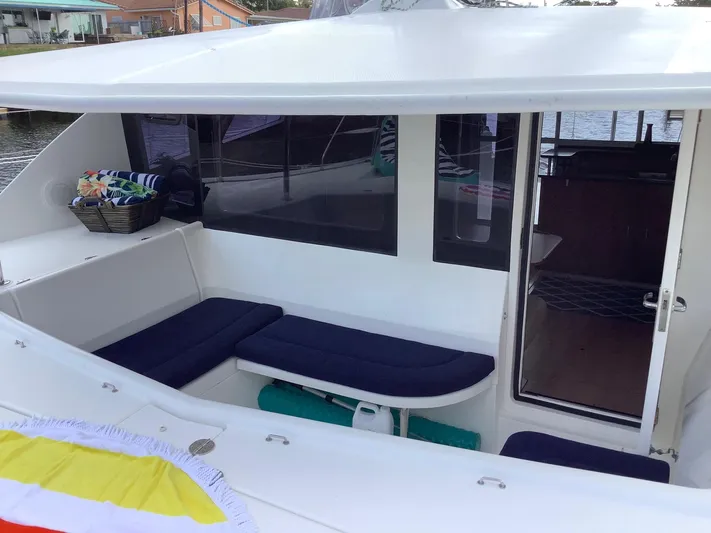 Merry Mac Yacht Photos Pics Leopard 44 catamaran 2013, featuring outdoor seating and cabin entrance.