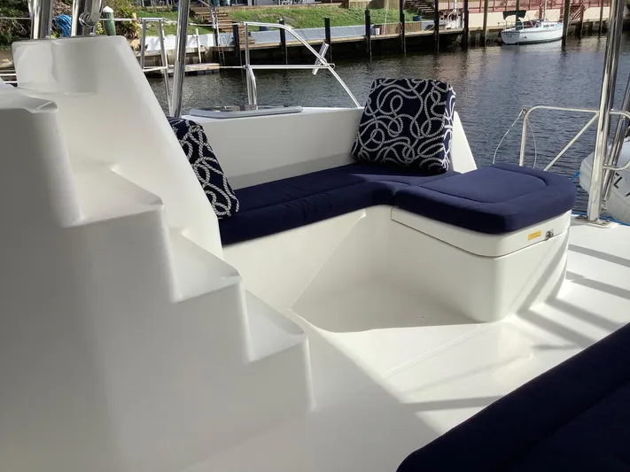 Merry Mac Yacht Photos Pics 2013 Leopard 44 yacht deck with blue cushioned seating and nautical-themed pillows.