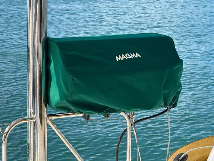Merry Mac Yacht Photos Pics Green Magma grill cover on a Leopard 44 boat, 2013 model, near water.