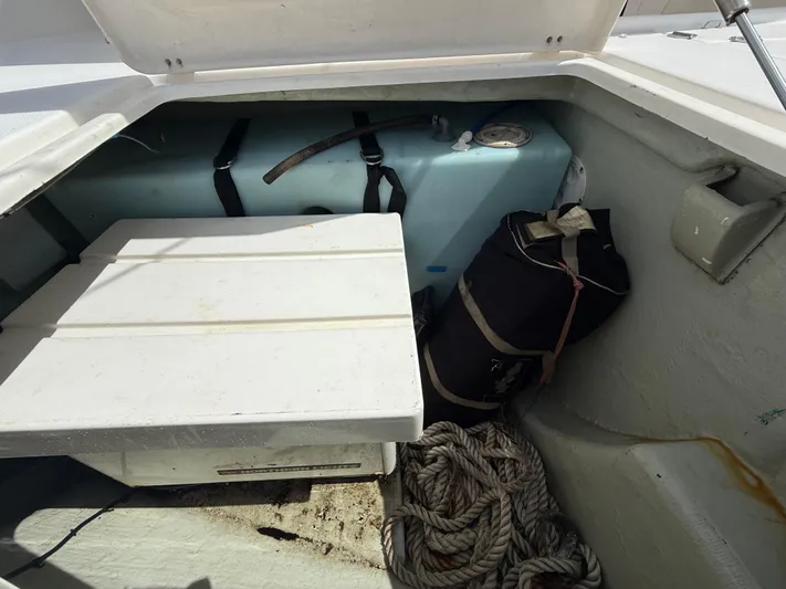 Merry Mac Yacht Photos Pics Storage compartment of a 2013 Leopard 44 boat with ropes and equipment.