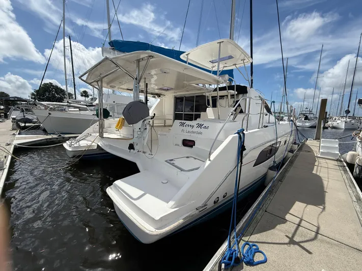 Merry Mac Yacht Photos Pics 2013 Leopard 44 catamaran docked at marina, sunny day, blue sky, "Merry Mac" on stern.
