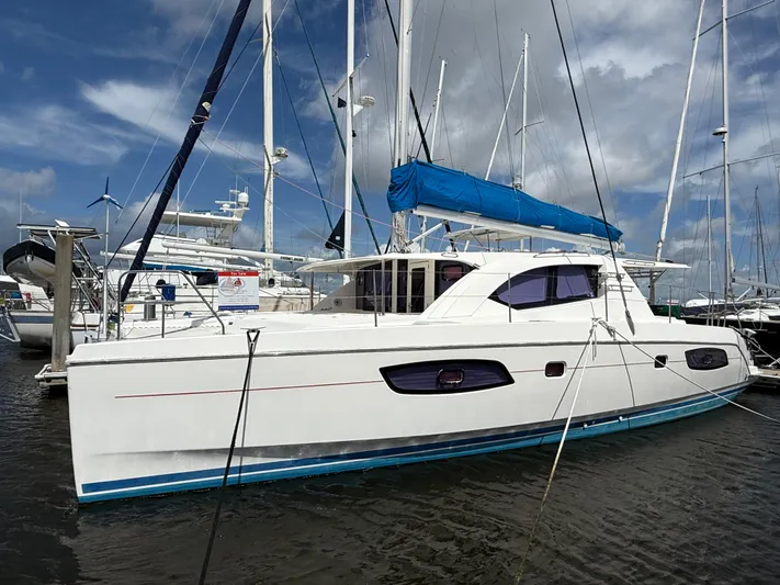 Merry Mac Yacht Photos Pics 2013 Leopard 44 catamaran docked at marina, featuring blue sail cover.