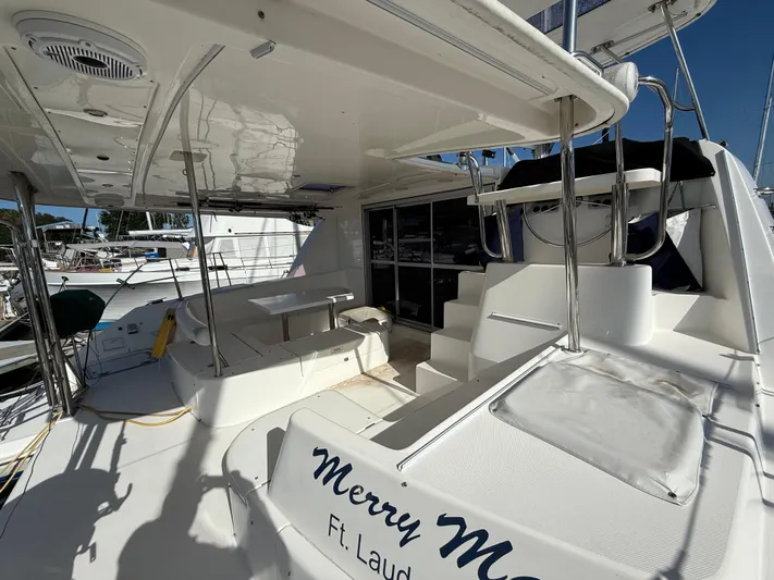Merry Mac Yacht Photos Pics Leopard 44 catamaran deck, 2013 model, featuring seating and table, docked in Ft. Lauderdale.