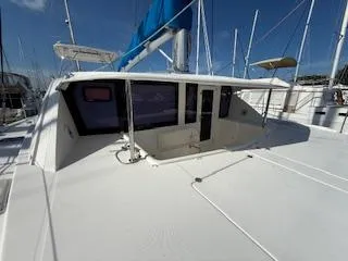 Merry Mac Yacht Photos Pics 2013 Leopard 44 catamaran with blue sail, docked in marina under clear sky.