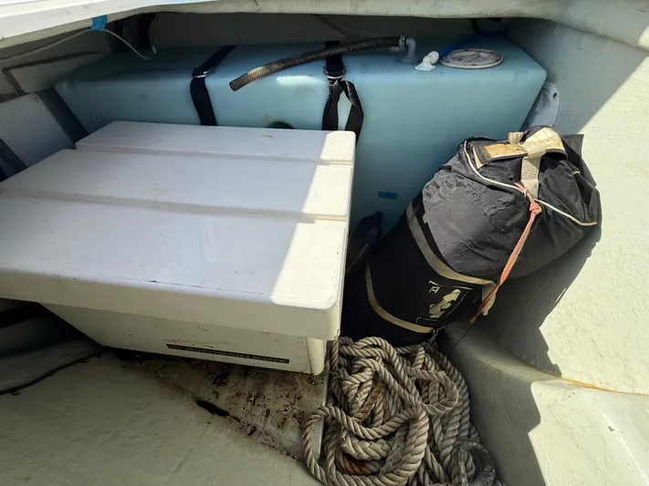 Merry Mac Yacht Photos Pics Storage compartment in a 2013 Leopard 44 boat with ropes and equipment.
