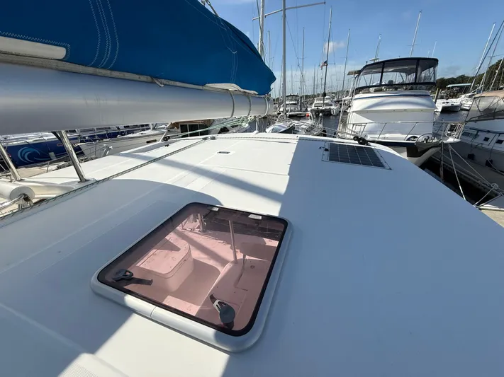 Merry Mac Yacht Photos Pics 2013 Leopard 44 catamaran deck with hatch, docked in a marina.