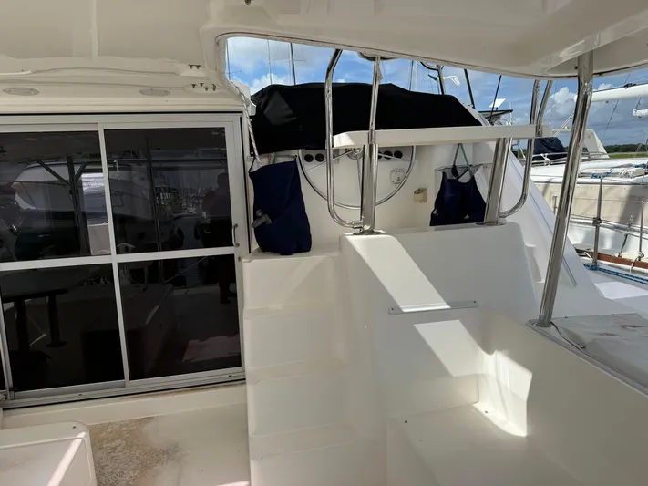Merry Mac Yacht Photos Pics Interior view of a 2013 Leopard 44 catamaran, featuring stairs and a sliding glass door.