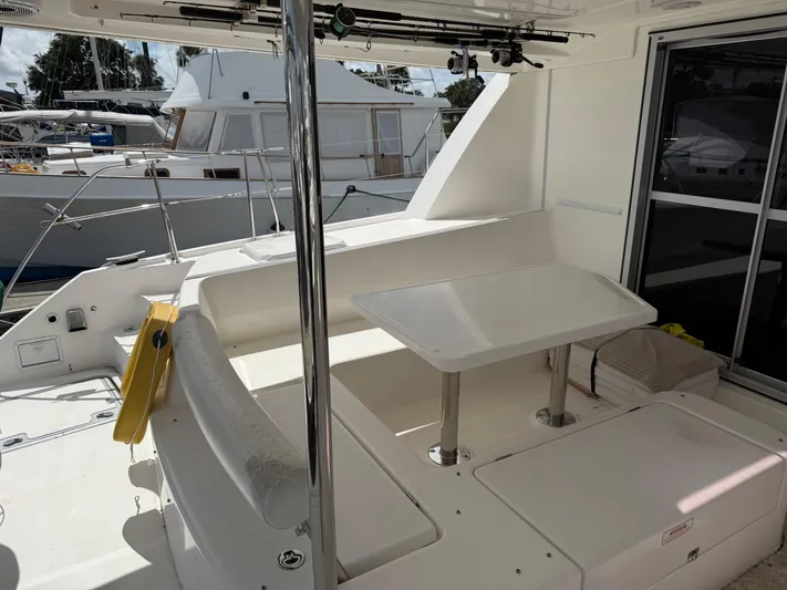 Merry Mac Yacht Photos Pics Leopard 44 yacht deck with seating and table, docked at marina, 2013 model.