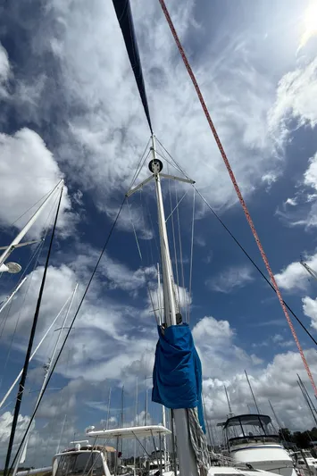 Merry Mac Yacht Photos Pics Sailboat mast against a cloudy sky, Leopard 44 model, 2013.