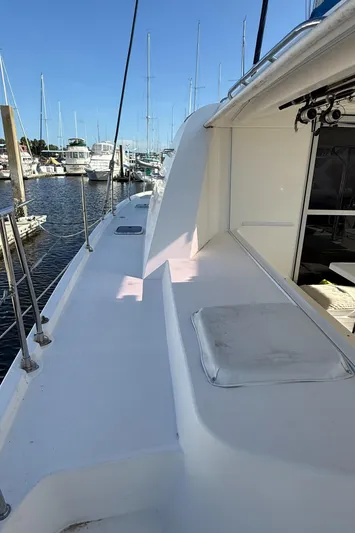 Merry Mac Yacht Photos Pics 2013 Leopard 44 catamaran deck view in marina, showcasing sleek design and spacious layout.