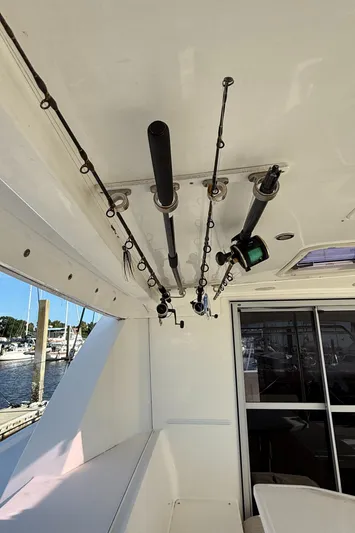 Merry Mac Yacht Photos Pics Fishing rods stored on a 2013 Leopard 44 boat, docked at a marina.