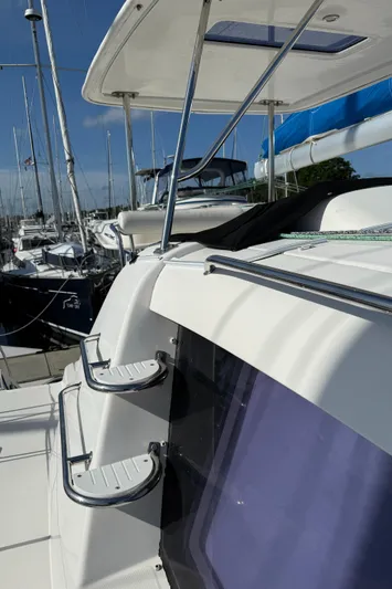 Merry Mac Yacht Photos Pics Leopard 44 catamaran, 2013 model, docked in a marina with clear blue skies.