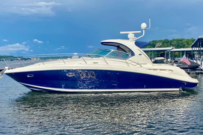  Yacht Photos Pics 2007 Sea Ray 38 Sundancer yacht on calm water, blue and white design.