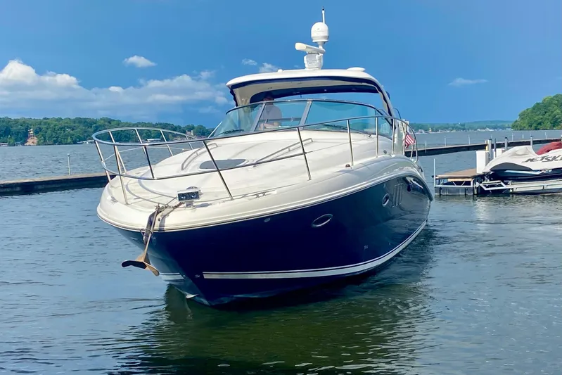  Yacht Photos Pics 2007 Sea Ray 38 Sundancer yacht docked on a serene lake under a clear blue sky.