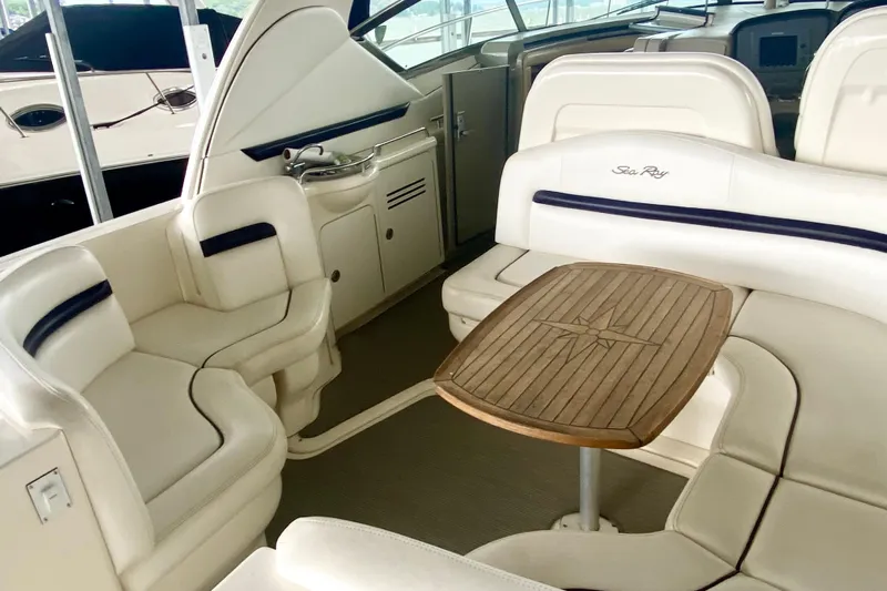  Yacht Photos Pics Luxurious interior of 2007 Sea Ray 38 Sundancer yacht with elegant seating and wooden table.