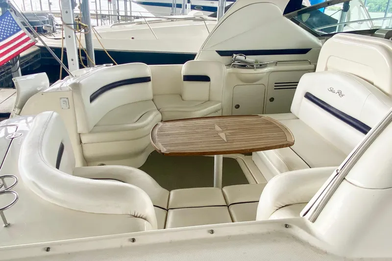  Yacht Photos Pics 2007 Sea Ray 38 Sundancer boat interior with white seating and wooden table.