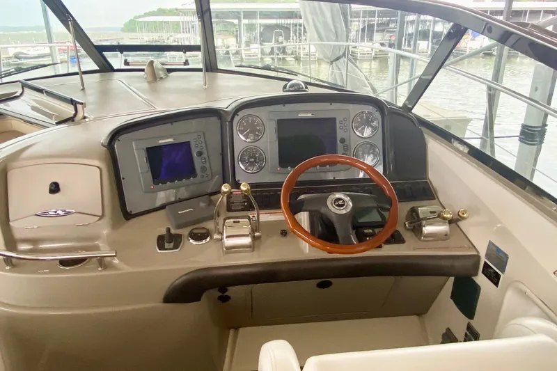  Yacht Photos Pics 2007 Sea Ray 38 Sundancer helm with navigation controls and wooden steering wheel.