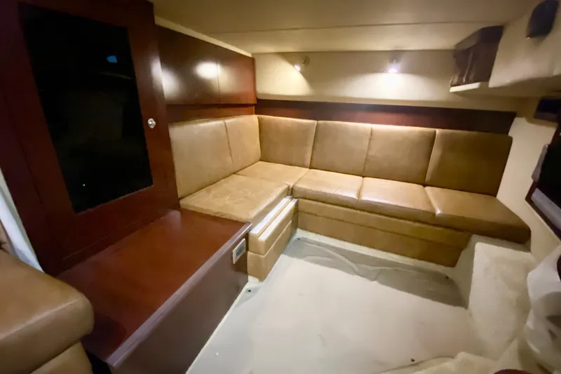  Yacht Photos Pics Luxurious interior of 2007 Sea Ray 38 Sundancer with leather seating and wooden cabinetry.