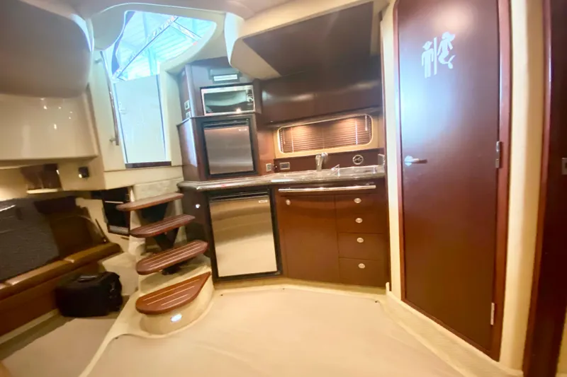  Yacht Photos Pics Interior of 2007 Sea Ray 38 Sundancer yacht with kitchenette and wooden cabinetry.