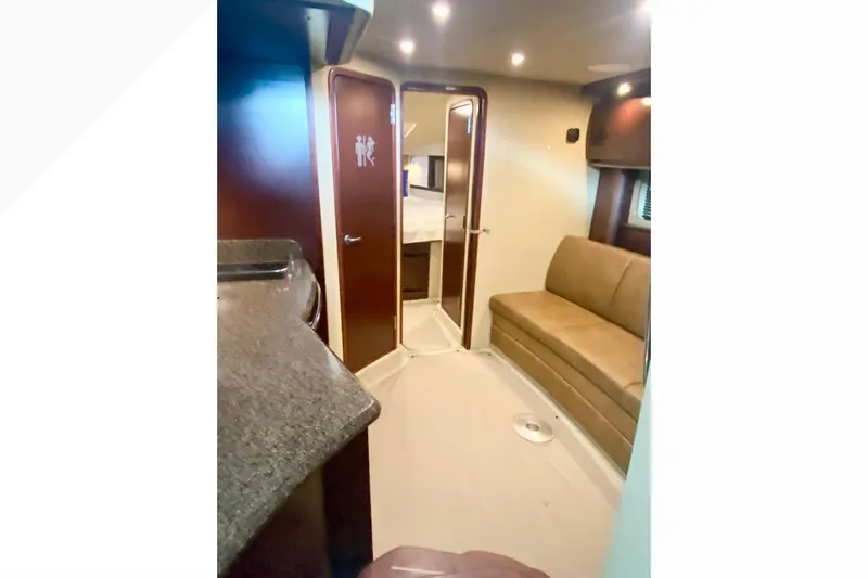  Yacht Photos Pics Interior of 2007 Sea Ray 38 Sundancer yacht with sofa and cabin door.