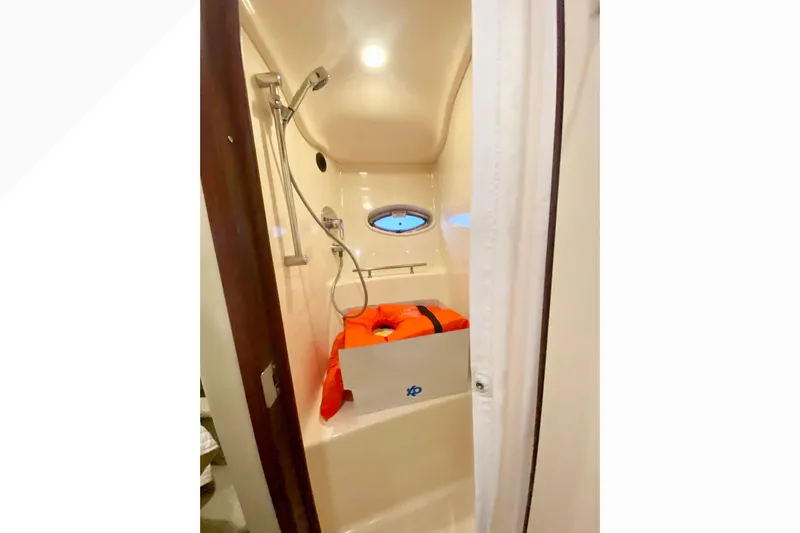  Yacht Photos Pics Shower area in 2007 Sea Ray 38 Sundancer yacht with porthole and life jacket.
