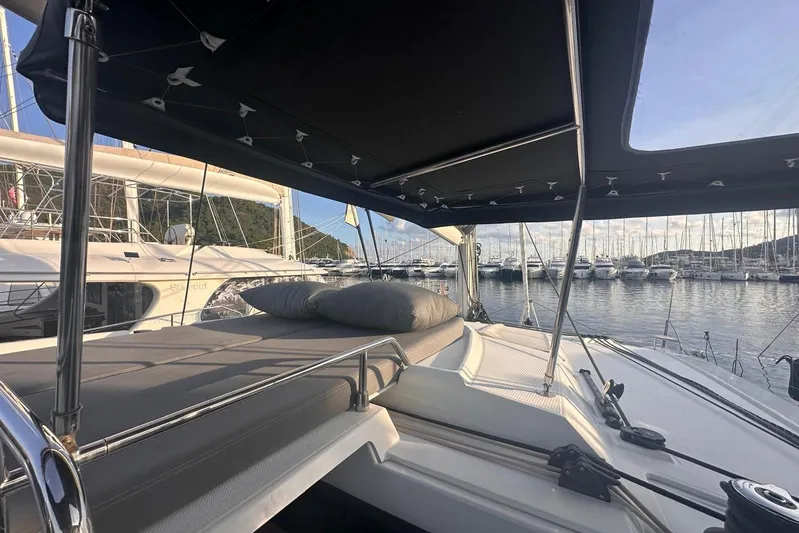  Yacht Photos Pics 2020 Fountaine Pajot Saona 47 catamaran with sunbed, docked in a marina.