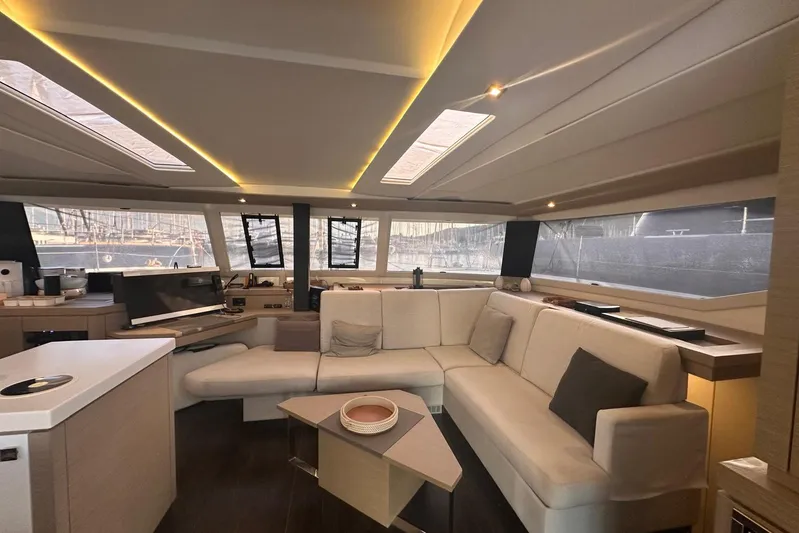  Yacht Photos Pics Luxurious interior of 2020 Fountaine Pajot Saona 47 catamaran with modern seating and panoramic windows.