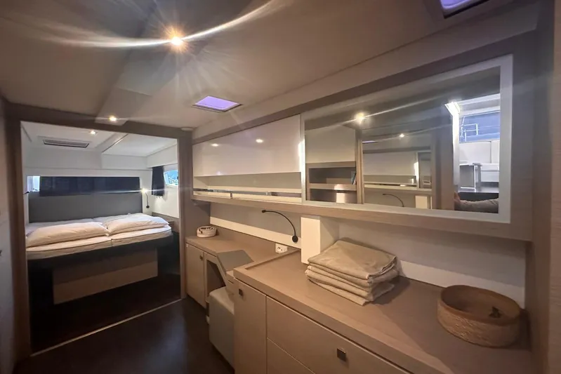  Yacht Photos Pics Luxurious interior of 2020 Fountaine Pajot Saona 47 catamaran, featuring a cozy bedroom and modern amenities.