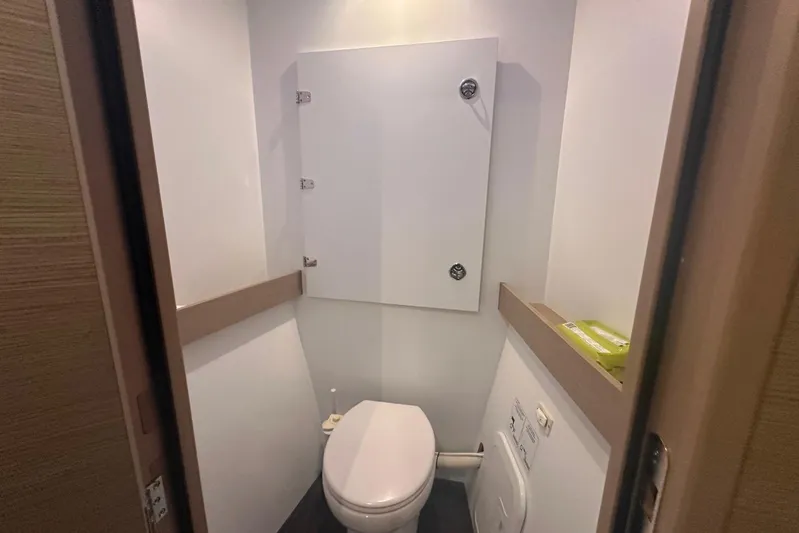 Yacht Photos Pics Compact bathroom in 2020 Fountaine Pajot Saona 47 yacht, featuring modern toilet and storage.
