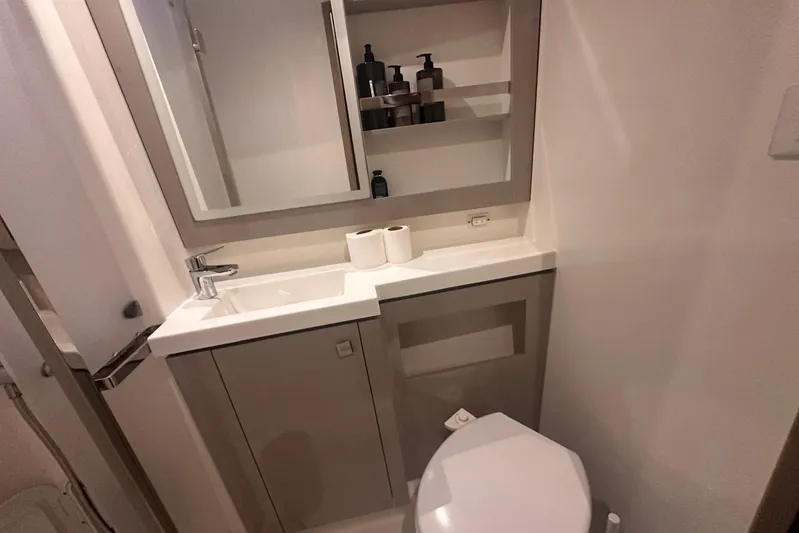  Yacht Photos Pics Modern bathroom in 2020 Fountaine Pajot Saona 47 yacht with sink, mirror, and toilet.