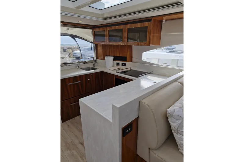 Mon Trésor Yacht Photos Pics Luxurious interior of 2020 Riviera 6000 Sport Yacht Platinum Edition with modern kitchen design.