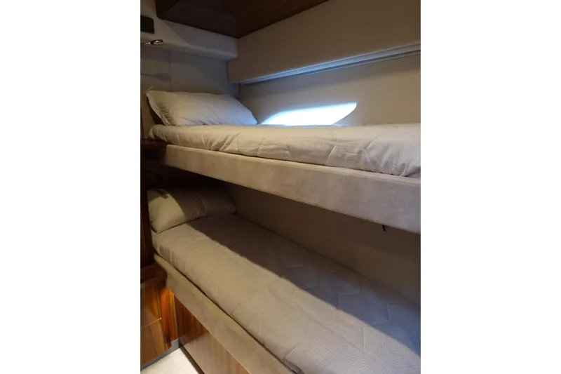 Mon Trésor Yacht Photos Pics 2020 Riviera 6000 Sport Yacht Platinum Edition interior with cozy bunk beds.
