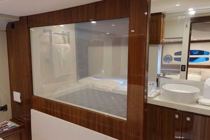 Mon Trésor Yacht Photos Pics Luxurious interior of 2020 Riviera 6000 Sport Yacht Platinum Edition with elegant wood finishes.