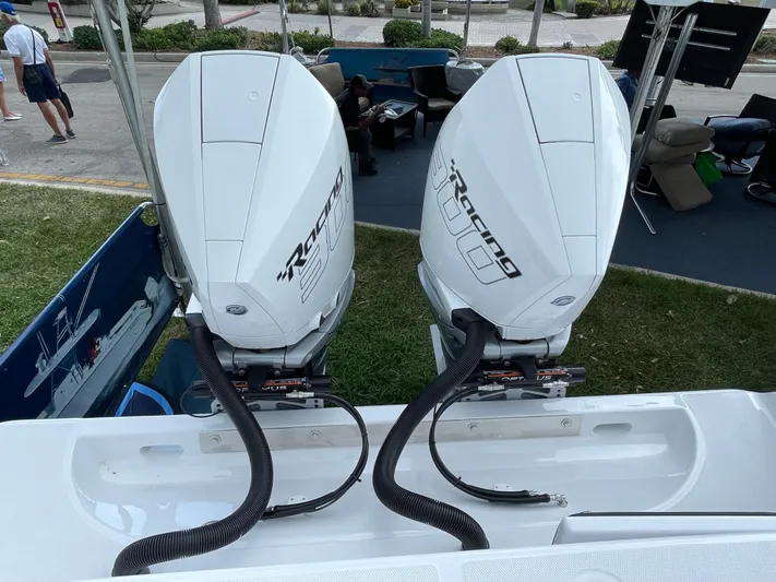 Reel Chaos Yacht Photos Pics Twin outboard engines on a 2022 Bahama 35 Open boat, displayed outdoors.