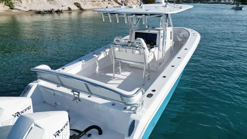 Reel Chaos Yacht Photos Pics 2022 Bahama 35 Open boat on clear water, featuring sleek design and powerful engines.