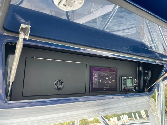 Reel Chaos Yacht Photos Pics Control panel of 2022 Bahama 35 Open boat with navigation instruments.