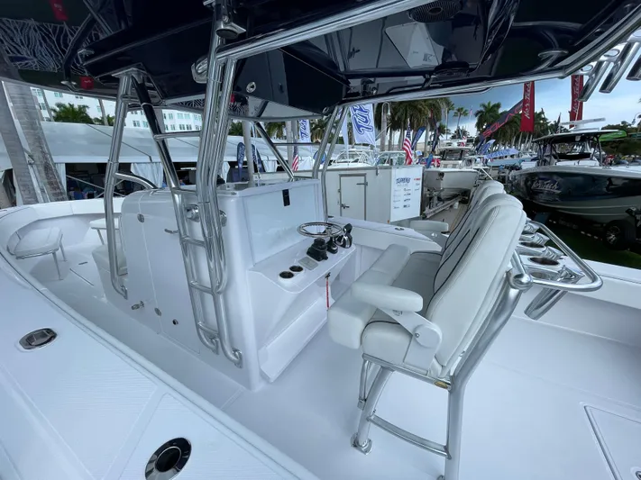Reel Chaos Yacht Photos Pics 2022 Bahama 35 Open boat interior with sleek white seating and modern controls.