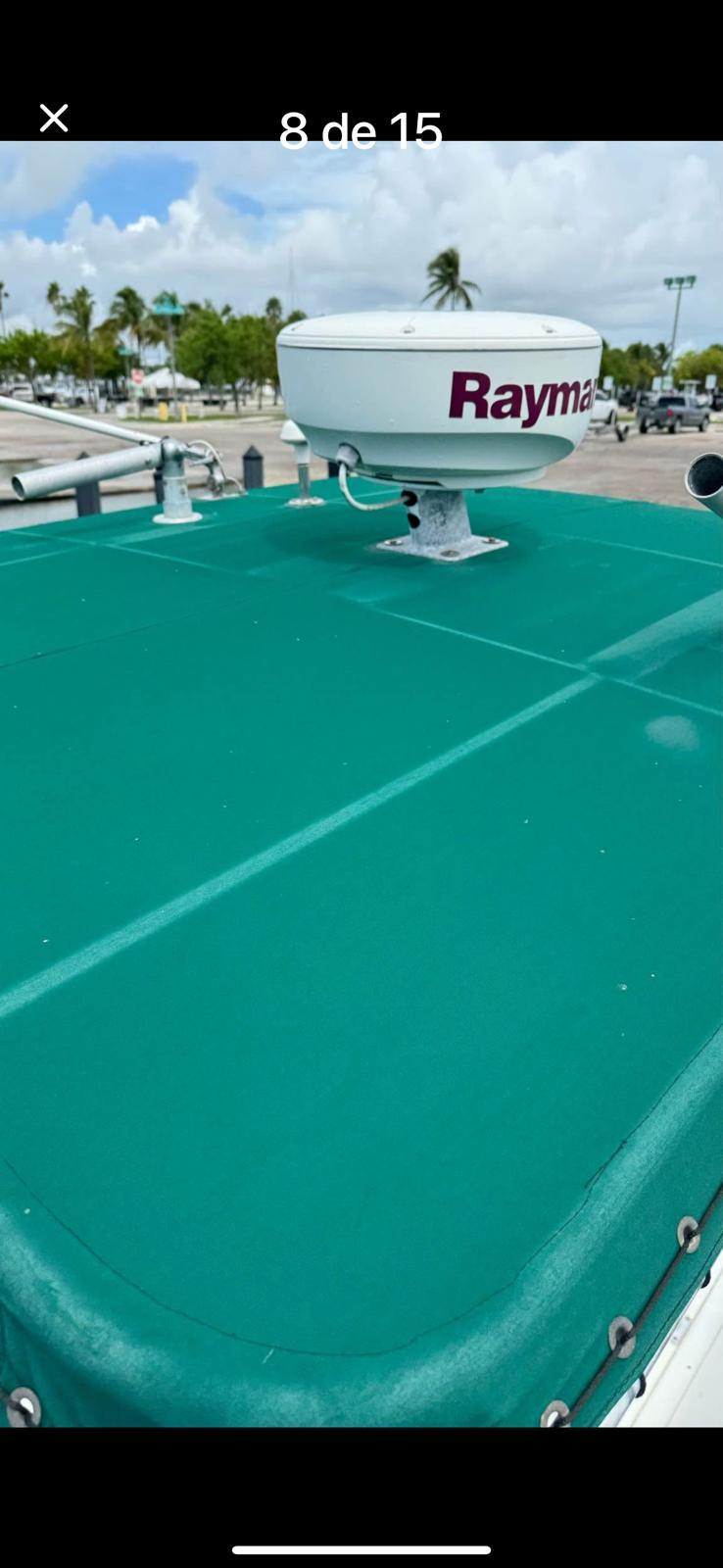 Stamas 250 Tarpon 2000 boat with green cover and Raymarine radar on deck.