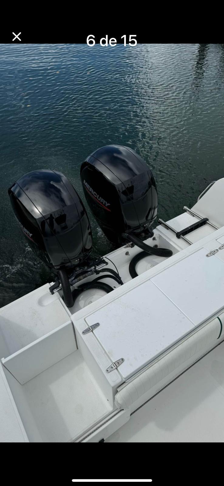 2000 Stamas 250 Tarpon boat with dual outboard engines on calm water.