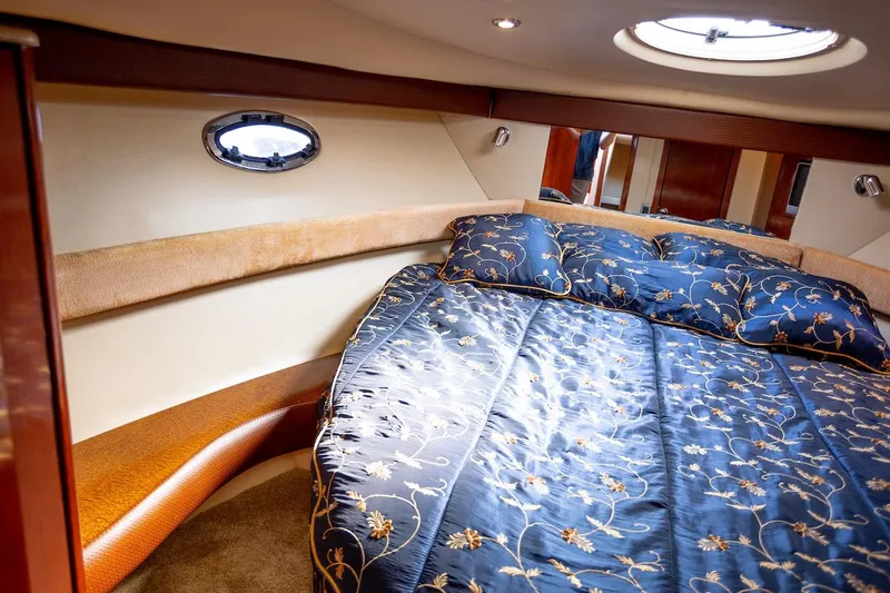 Seacougs Yacht Photos Pics Luxurious 2008 Meridian 341 Sedan cabin with elegant bedding and porthole window.