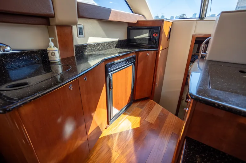 Seacougs Yacht Photos Pics Luxurious 2008 Meridian 341 Sedan yacht kitchen with wood cabinetry and modern appliances.