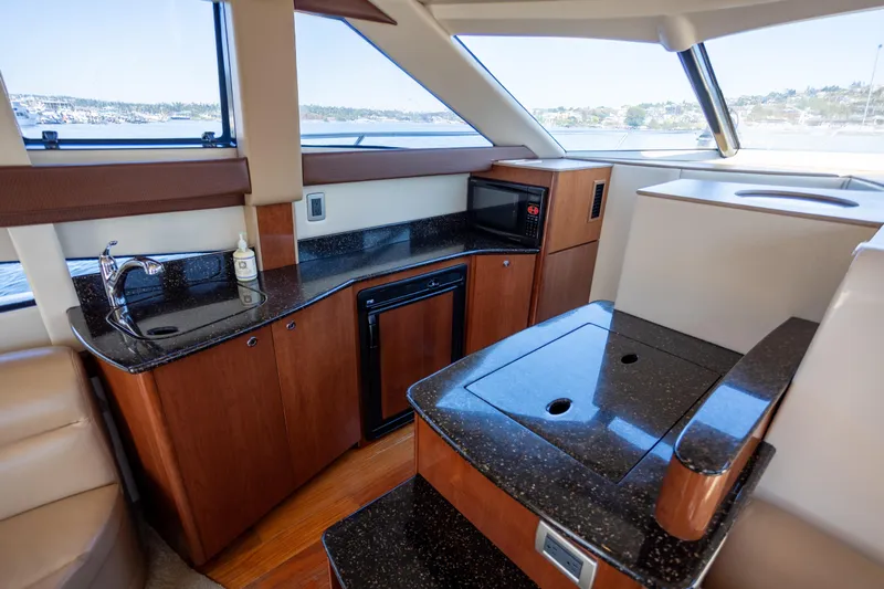 Seacougs Yacht Photos Pics Luxurious 2008 Meridian 341 Sedan yacht interior with kitchenette and sleek countertops.