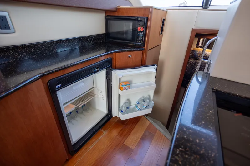 Seacougs Yacht Photos Pics 2008 Meridian 341 Sedan yacht kitchen with open fridge and microwave.