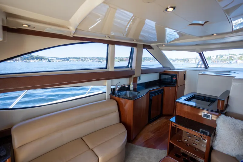 Seacougs Yacht Photos Pics Luxurious interior of a 2008 Meridian 341 Sedan yacht with modern amenities and scenic water views.