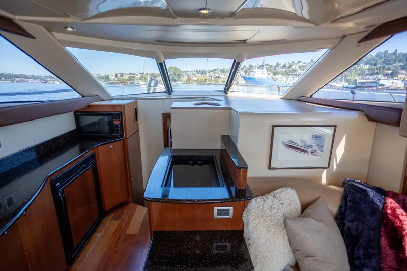 Seacougs Yacht Photos Pics Interior of 2008 Meridian 341 Sedan yacht with modern kitchen and cozy seating area.
