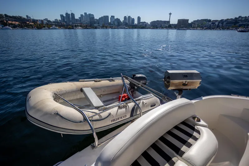 Seacougs Yacht Photos Pics 2008 Meridian 341 Sedan with inflatable boat on water, city skyline in background.